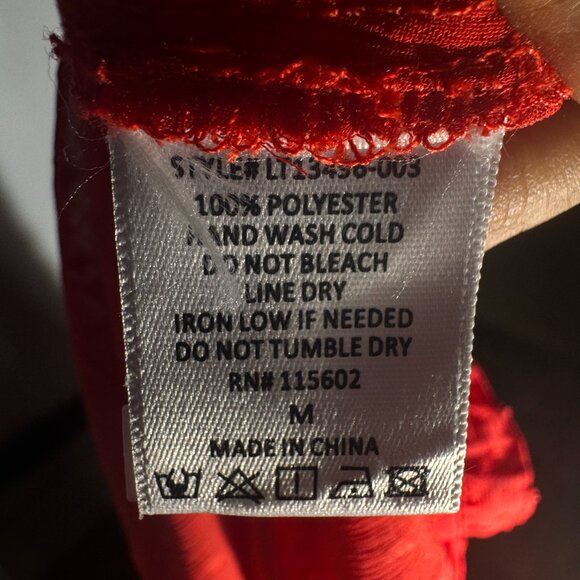 This LUSH red long sleeve blouse features a romantic Swiss dot texture and light - Picture 6 of 11